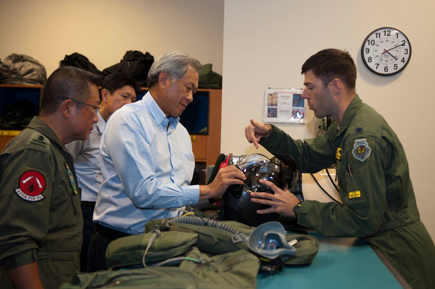 Singapore’s Minister for Defense, Dr. Ng Eng Hen, learns about the F-35 Helmet Mounted Display System during a visit to the 61st Fighter Squadron at Luke Air Force Base, Arizona, in December 2015. <em>U.S. Air Force photo by Staff Sgt. Staci Miller</em>