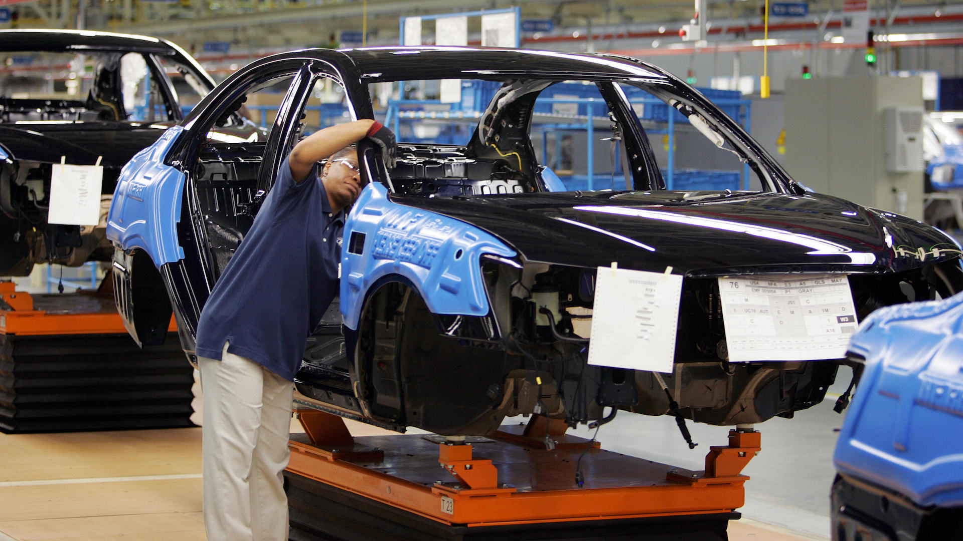 MONTGOMERY, UNITED STATES:  Hyundai employees work on a car on the assembly line 20 May 2005 during the grand opening of their plant in Montgomery, AL. This is the South Korean car manufacturers first production plant in the US, capable of producing 300,000 cars a year.  AFP PHOTO/ROBERT SULLIVAN  (Photo credit should read ROBERT SULLIVAN/AFP via Getty Images)
