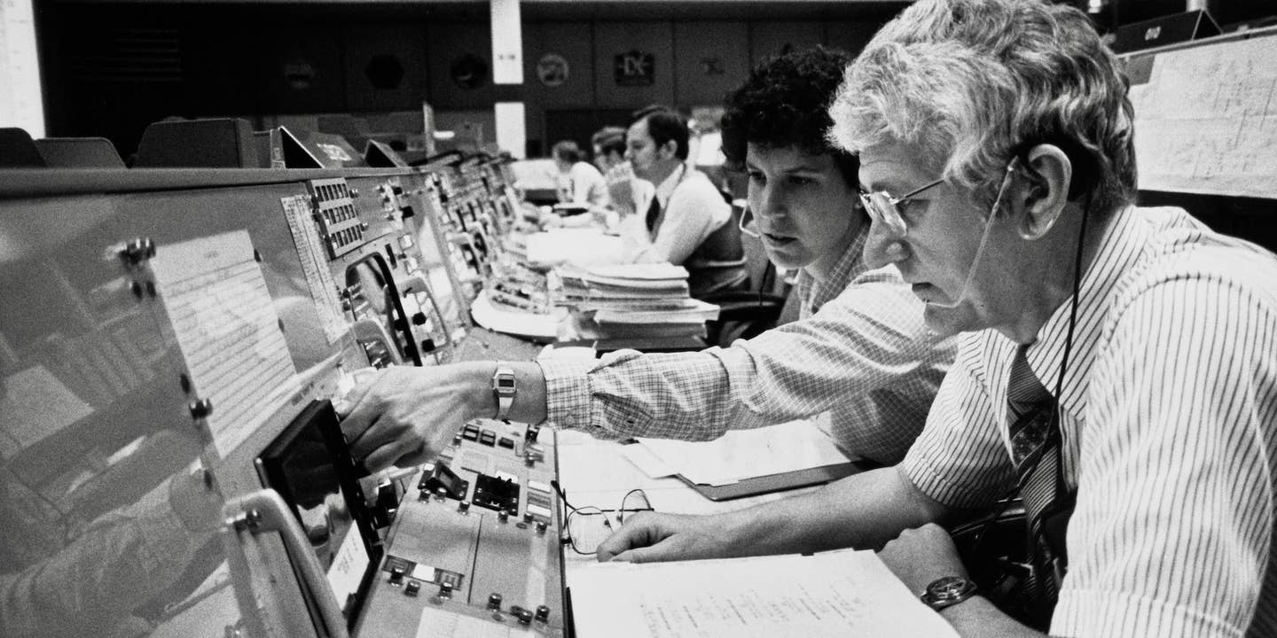 Astronauts Henry W Hartsfield and Ellen S Baker monitoring data