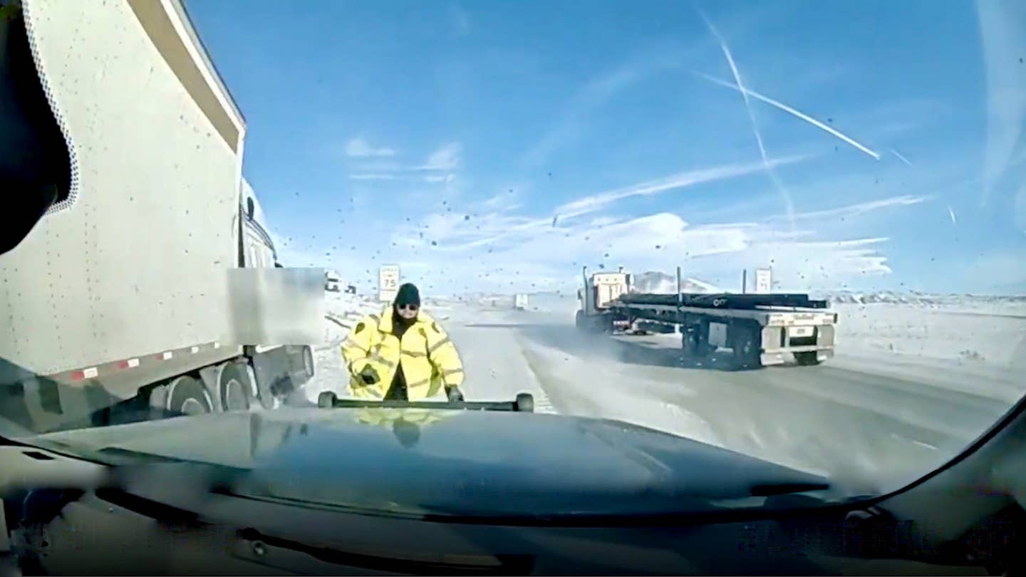 Watch a State Trooper Jump at Very Last Second to Avoid Out-of-Control Semi Truck