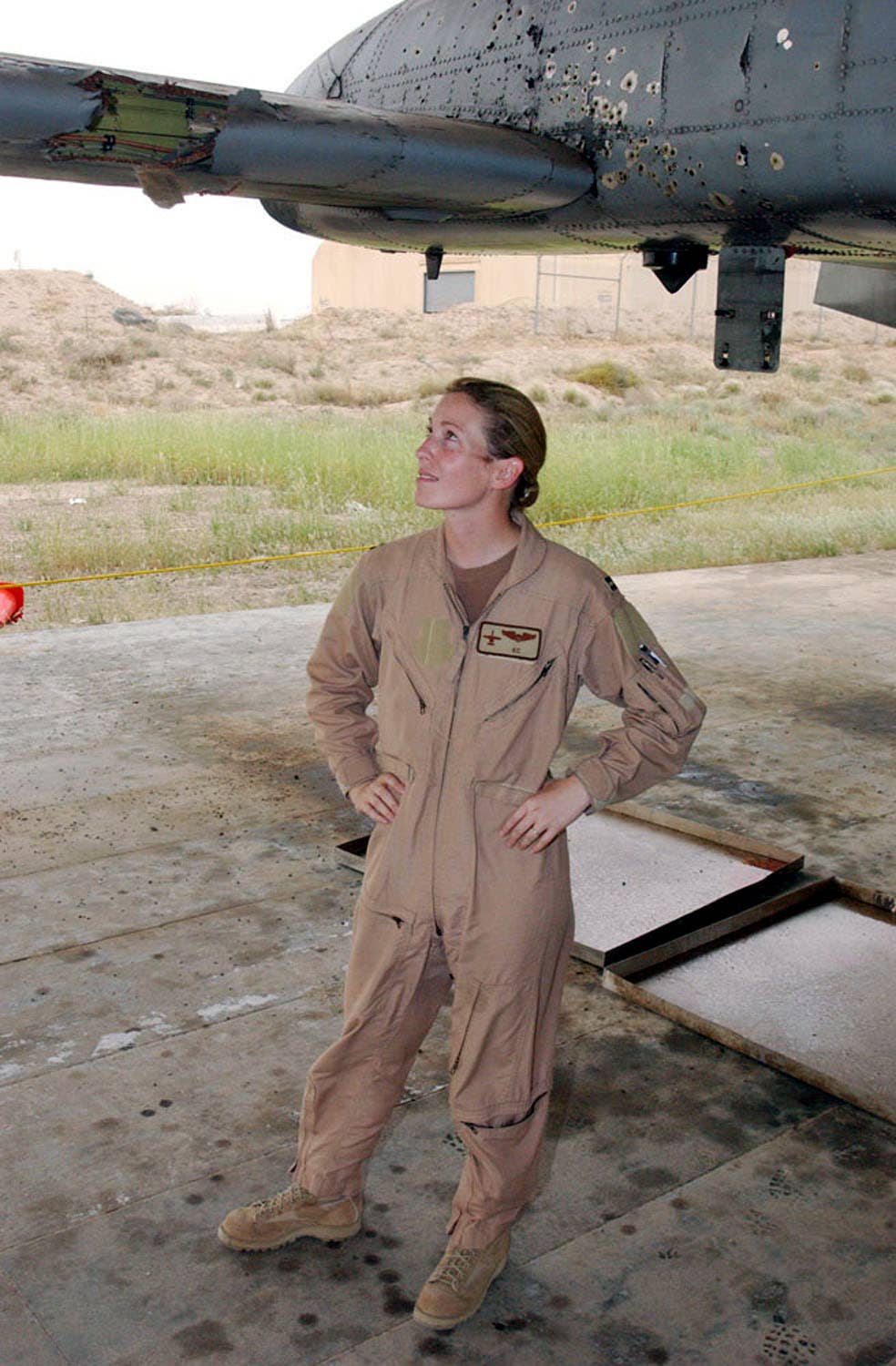 Then Capt. Kim Campbell surveys the battle damage to her airplane after it was hit over Baghdad during a close air support mission on April 7. <em>via Kim “KC” Campbell</em>
