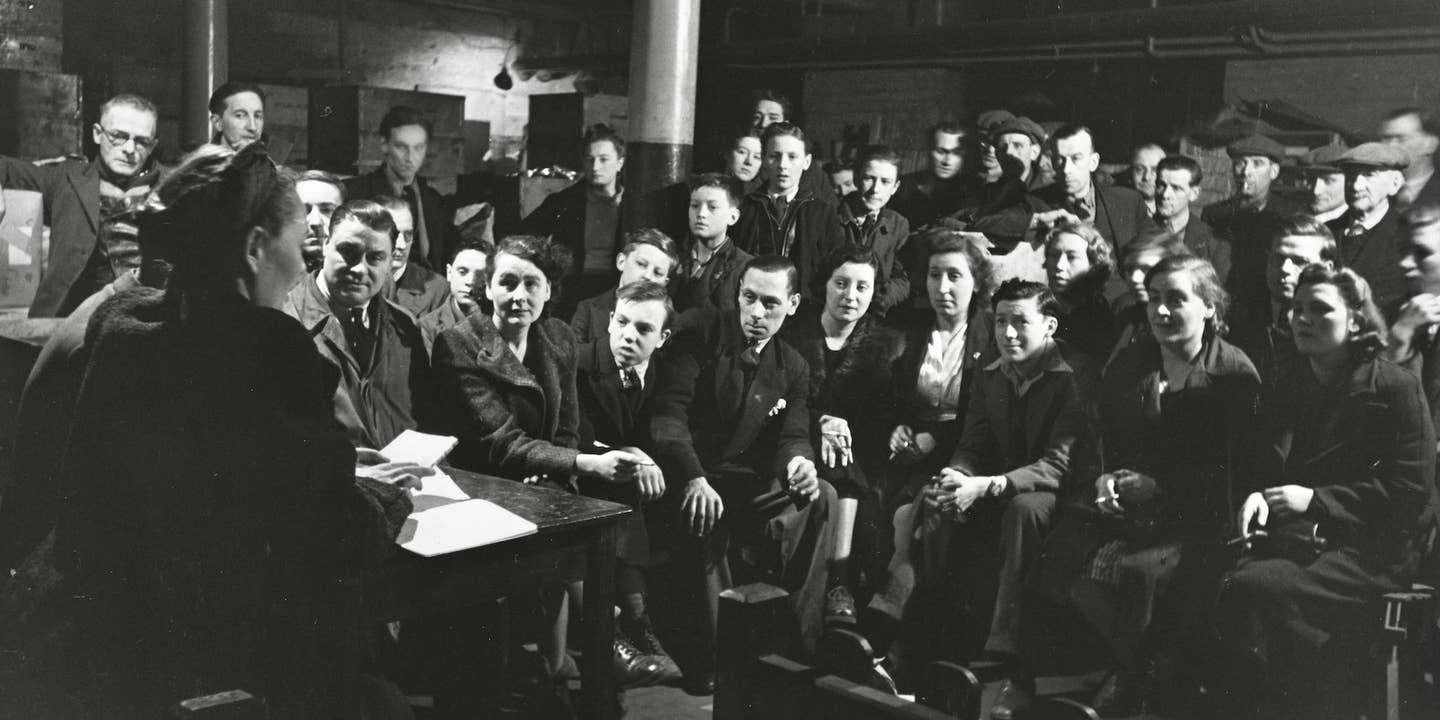 People listen to the speaker at a Discussion Circle in an air raid shelter in Bermondsey in 1940.
