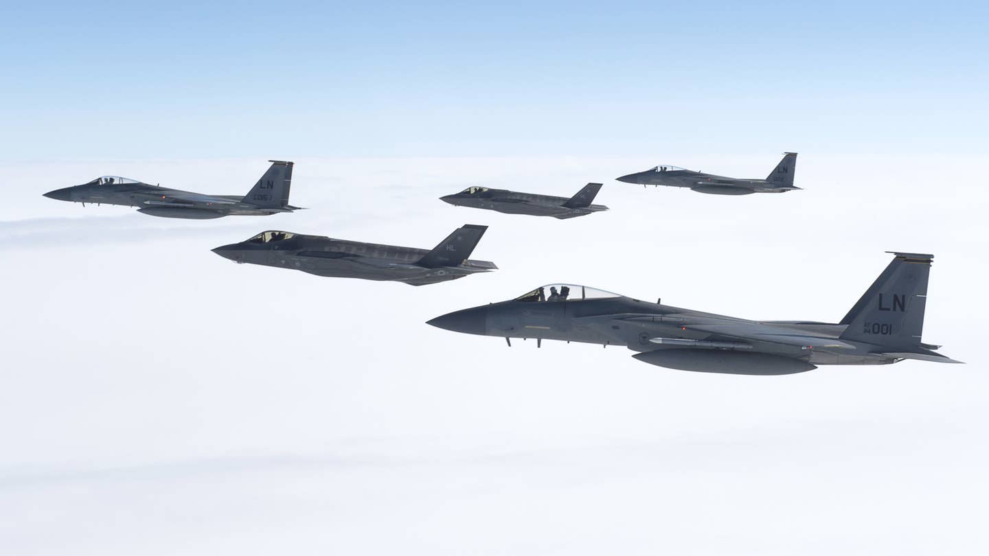 F-35A Joint Strike Fighters and F-15C Eagles fly in formation. <em>USAF</em>