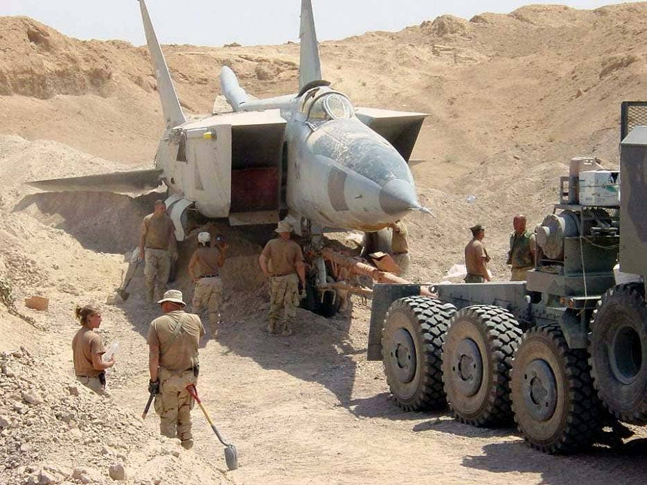 OPERATION IRAQI FREEDOM -- A U.S. military search team discovers a MiG-25 Foxbat, the world's fastest fighter, buried beneath the sands in Iraq. Several MiG-25s and Su-25 ground attack jets have been found buried at al-Taqqadum airfield west of Baghdad. <em>U.S. Air Force photo by Master Sgt. T. Collins</em>