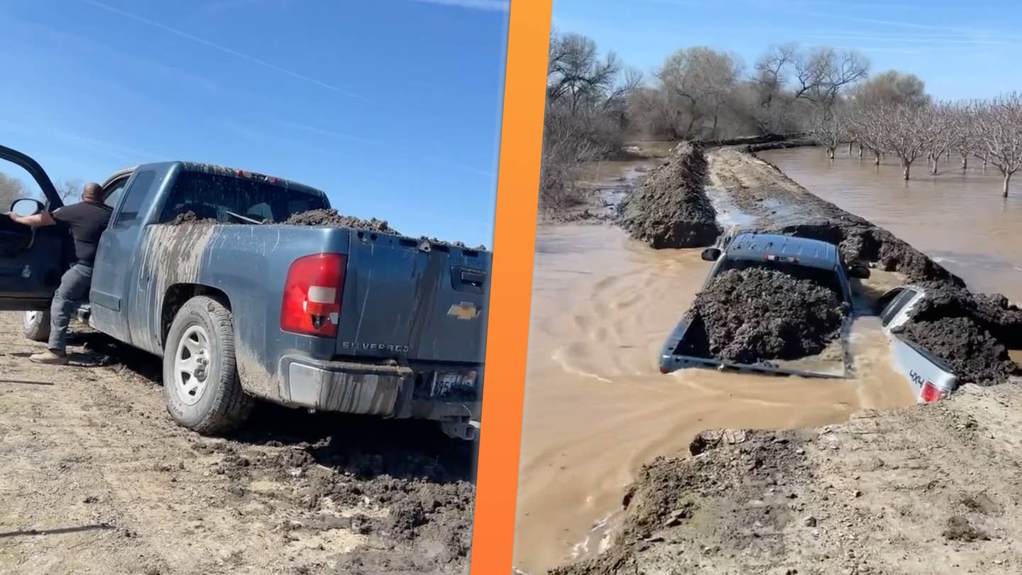 A Chevy Silverado and Ford F-150 with their beds full of dirt plug up a break in a levee at a pistachio orchard