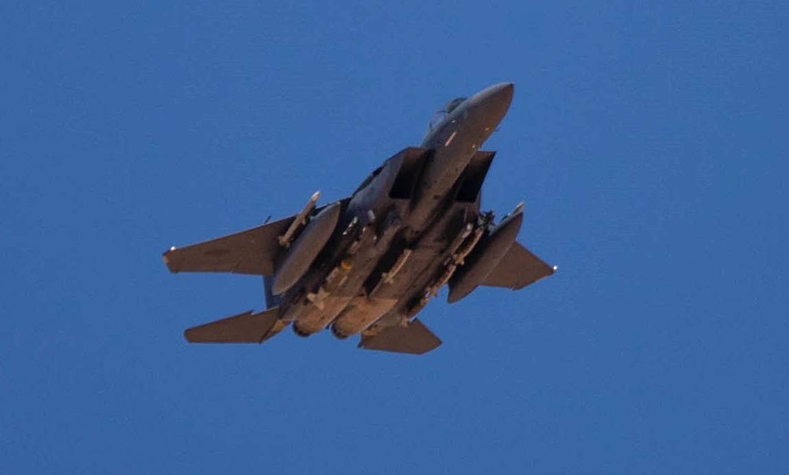 A heavily laden F-15E Strike Eagle photographed by U.S. forces on the ground at the garrison at At Tanf, Syria, during a training exercise in 2020. <em>U.S. Army</em>
