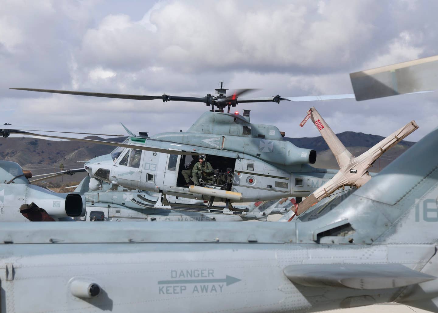 A UH-1Y operating among its parked attack and utility counterparts. (Author)