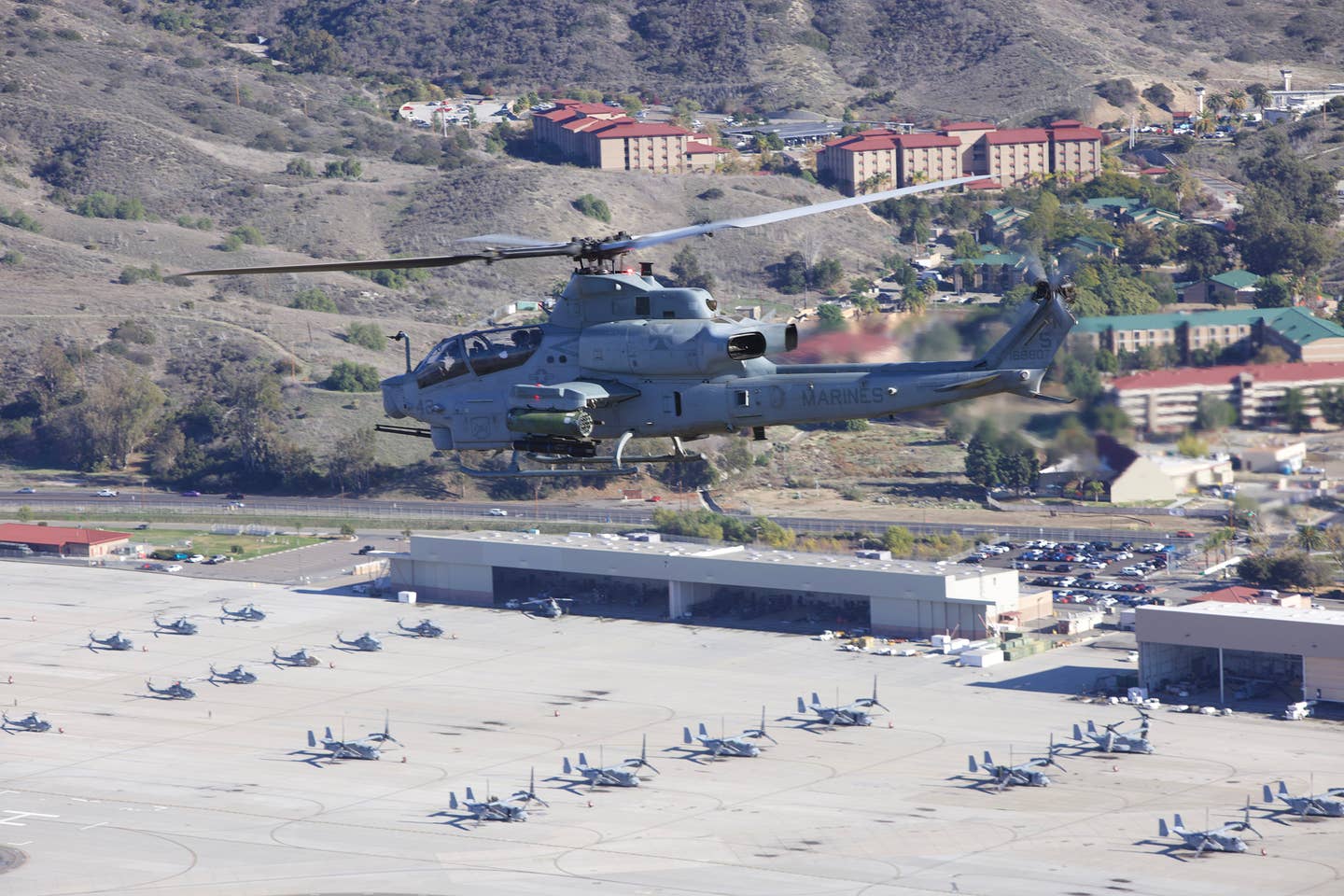 An AH-1Z flies over the flightline at Camp Pendleton. (Author)