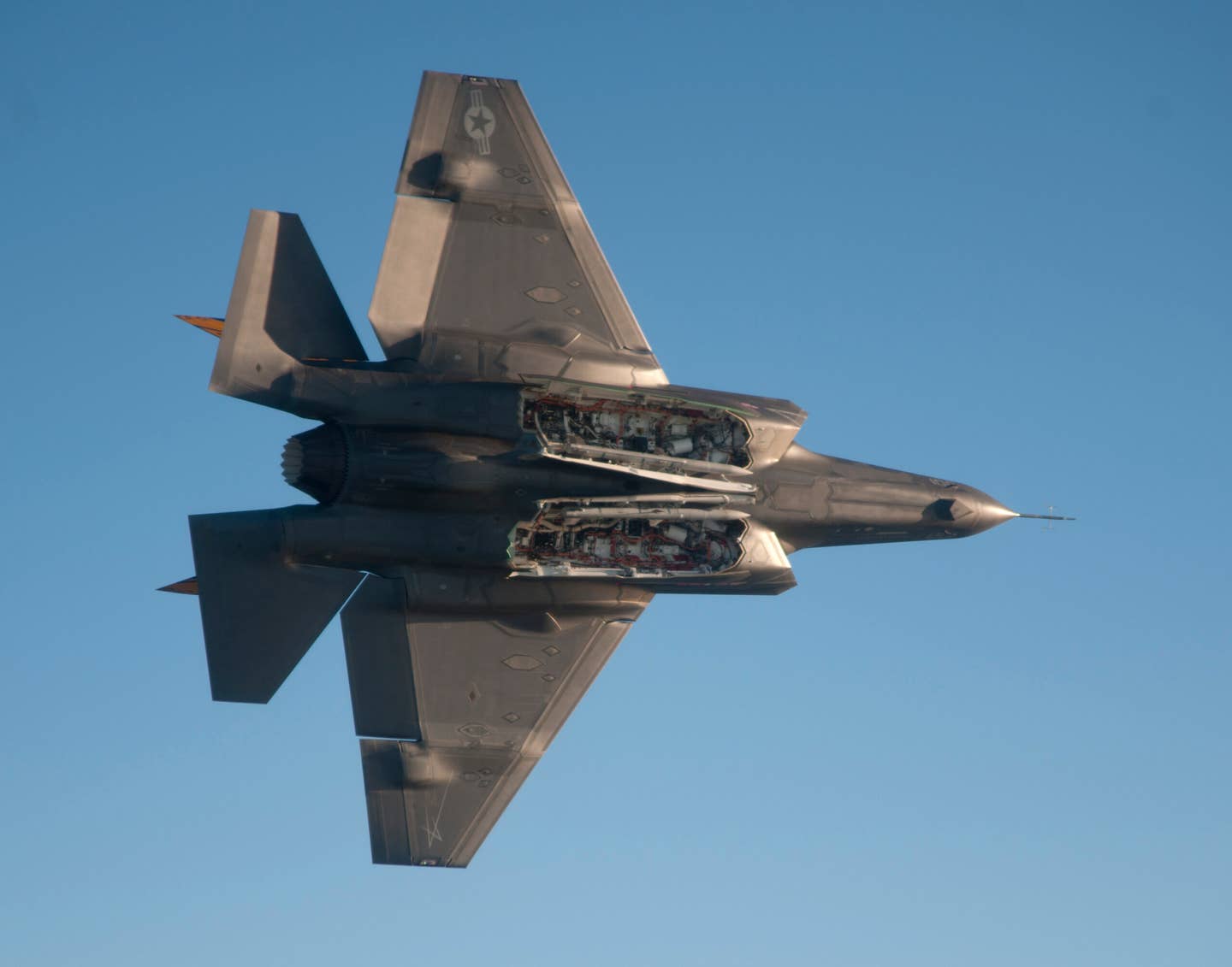 An F-35C is flown by test pilot Peter Wilson to evaluate the aircraft's flying qualities with the internal weapons bays open-loaded with AIM-120 Advanced Medium-range air-to-air missiles. <em>Credit: U.S. Navy photo courtesy of Lockheed Martin/by Andy Wolfe</em>