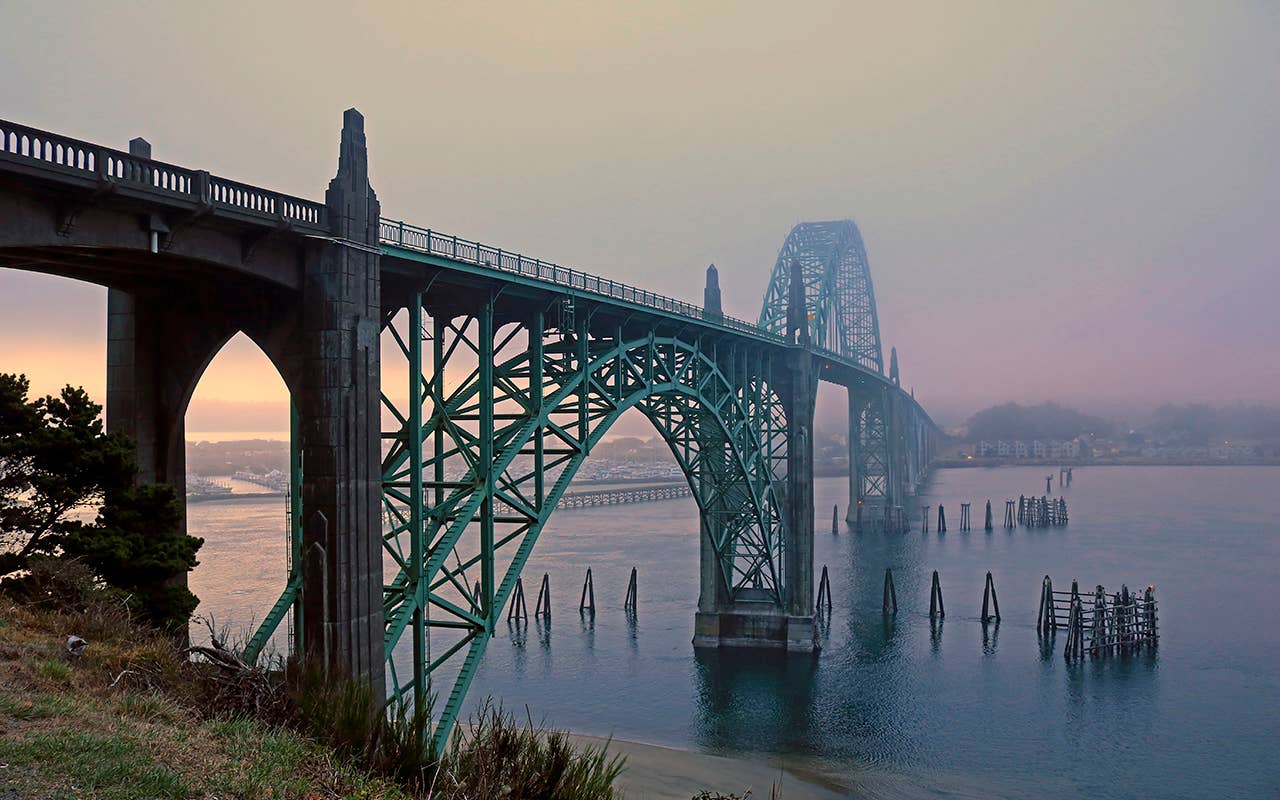 Foggy sunset at the Yaquina Bay bridge in Newport Oregon, This bridge is on US Highway 101 and spans Yaquina Bay in Newport along the central Oregon coast. (Photo by: Education Images/Universal Images Group via Getty Images)