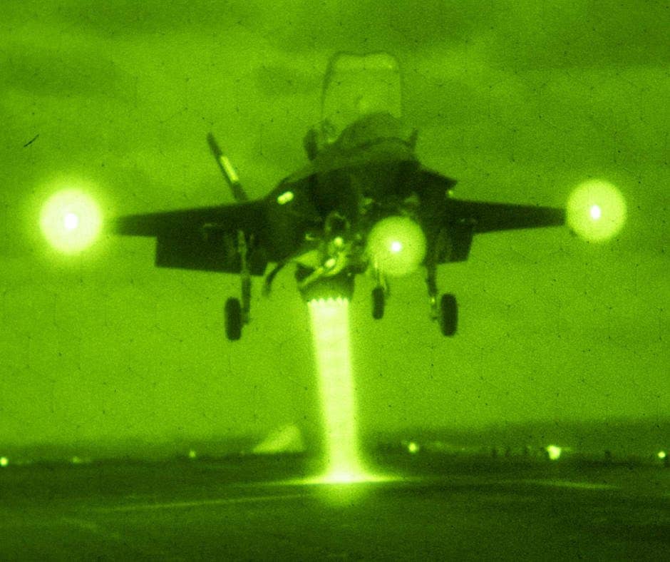 A US Marine Corps F-35B, seen through night vision optics, landing on the deck of the amphibious assault ship USS <em>America</em>. <em>DOD</em>