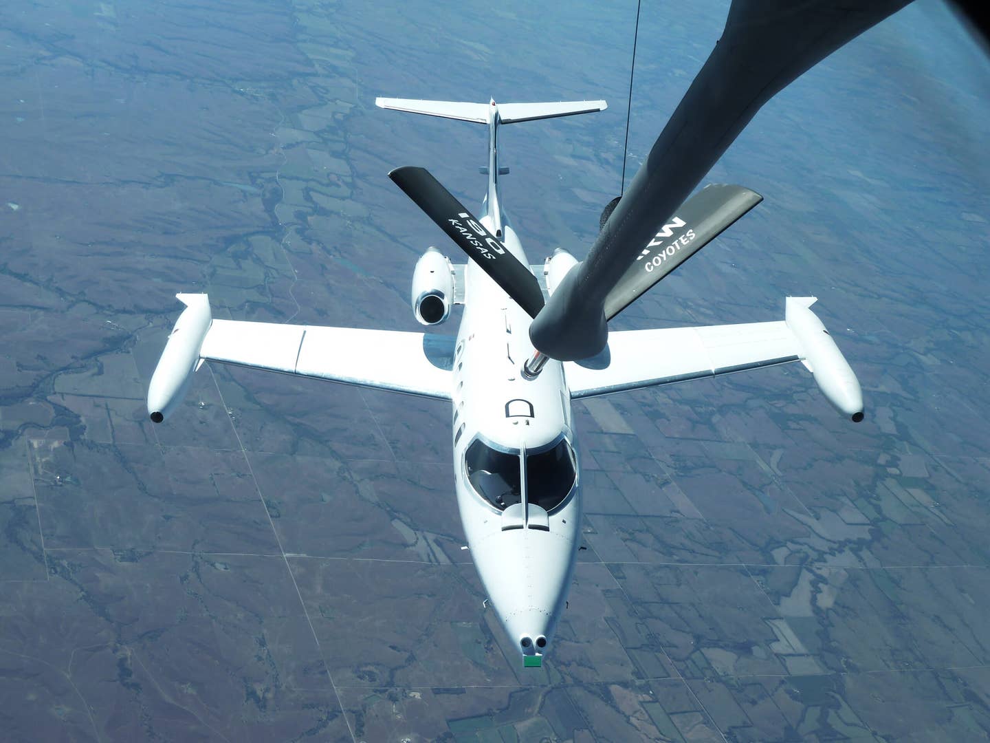 A Learjet, standing in for a Remotely Piloted Aircraft, flies into refueling position during Automated Aerial Refueling flights that tested Precision GPS algorithms and advanced sensors. <em>AFRL Image</em>