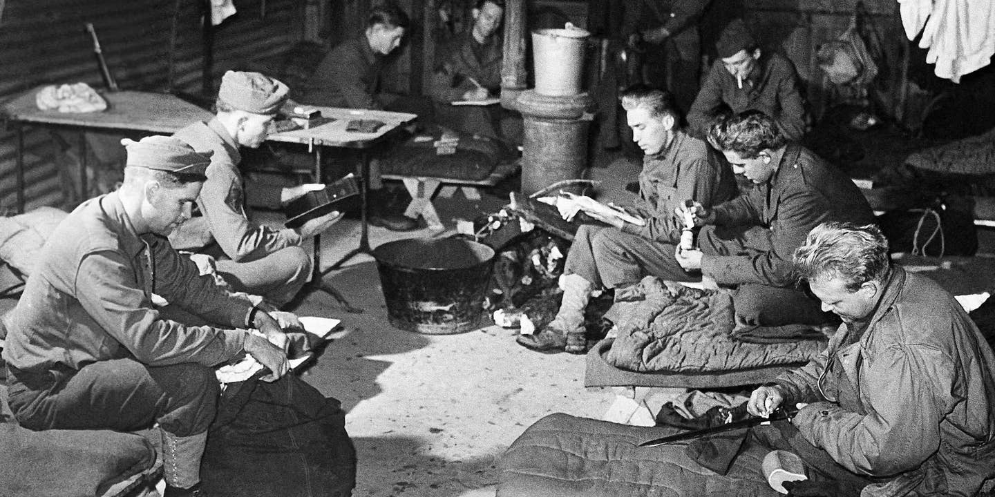 Soldiers pass the time reading while in their shelter