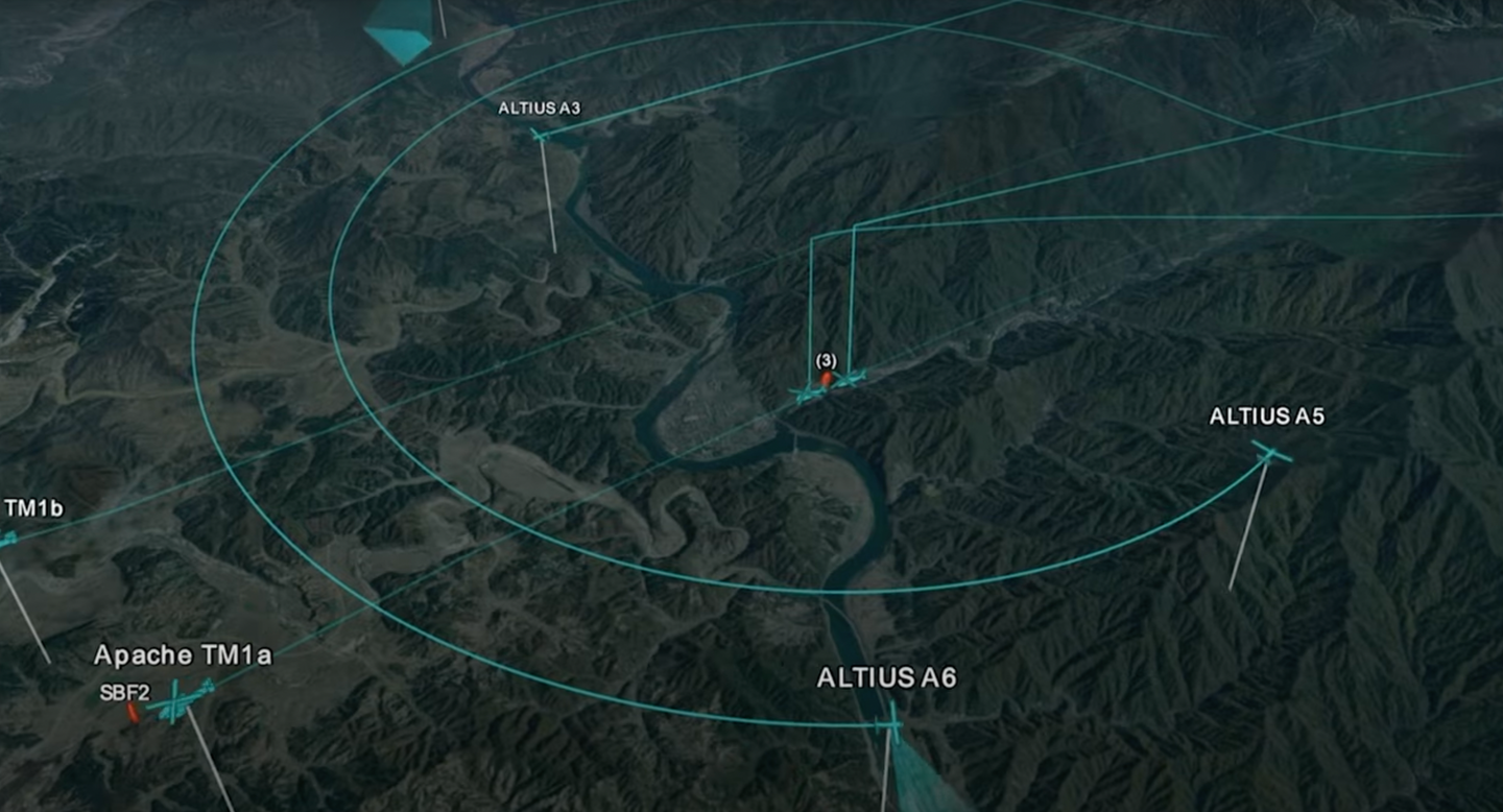 A computer-generated projection of a possible collaborative teaming setup involving ALTIUS-600 drones, working with AH-64 Apache attack helicopters. <em>Anduril Industries/YouTube screencap</em>