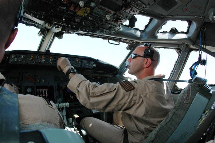 A Navy E-6B co-pilot enters information into the autopilot computer during a mission over Iraq.<em> U.S. Air Force photo/Staff Sgt. Cassandra Lock</em>