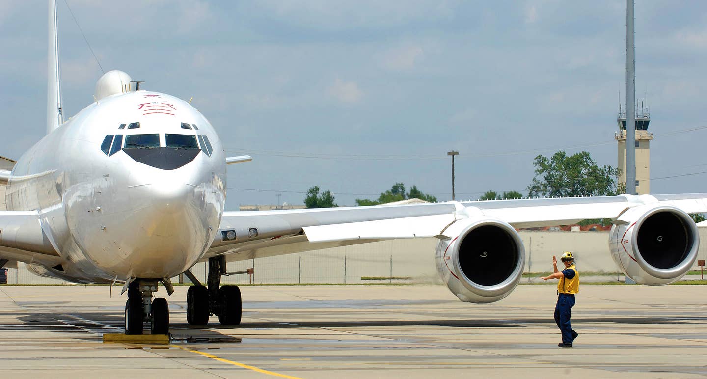 A member of the ground crew marshals an E-6B Mercury flown by Strategic Communications Wing One at Tinker Air Force Base, Oklahoma. <em>U.S. Air Force photo/Margo Wright</em>