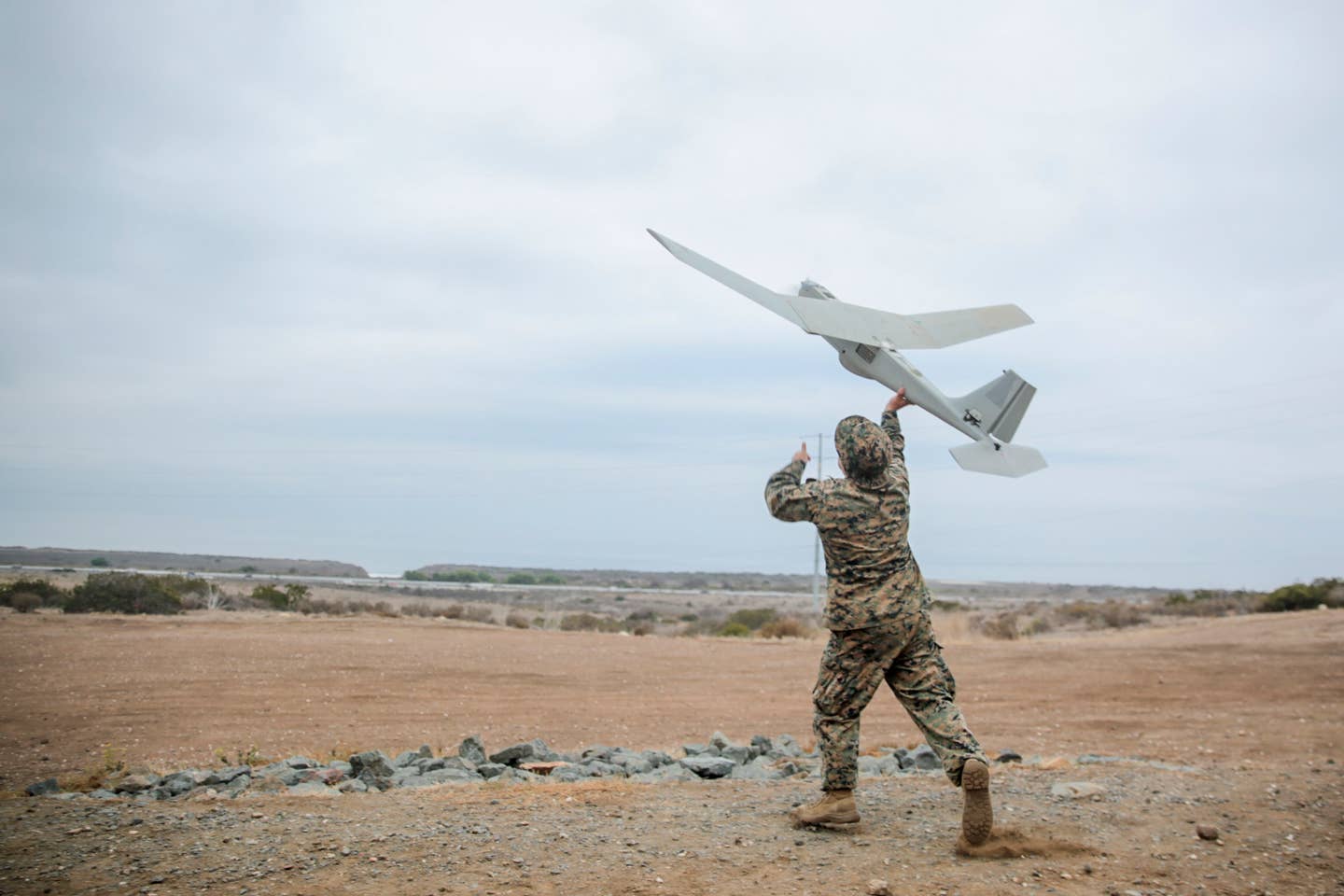 U.S. Marine Corps Sgt. Joseph Wiseman launches an RQ-20 Puma in support of 1st ANGLICO's field exercise on Marine Corps Base Camp Pendleton, California, Oct. 12, 2022. <em>Credit: U.S. Marine Corps photo by Sgt. Sarah Stegall</em>