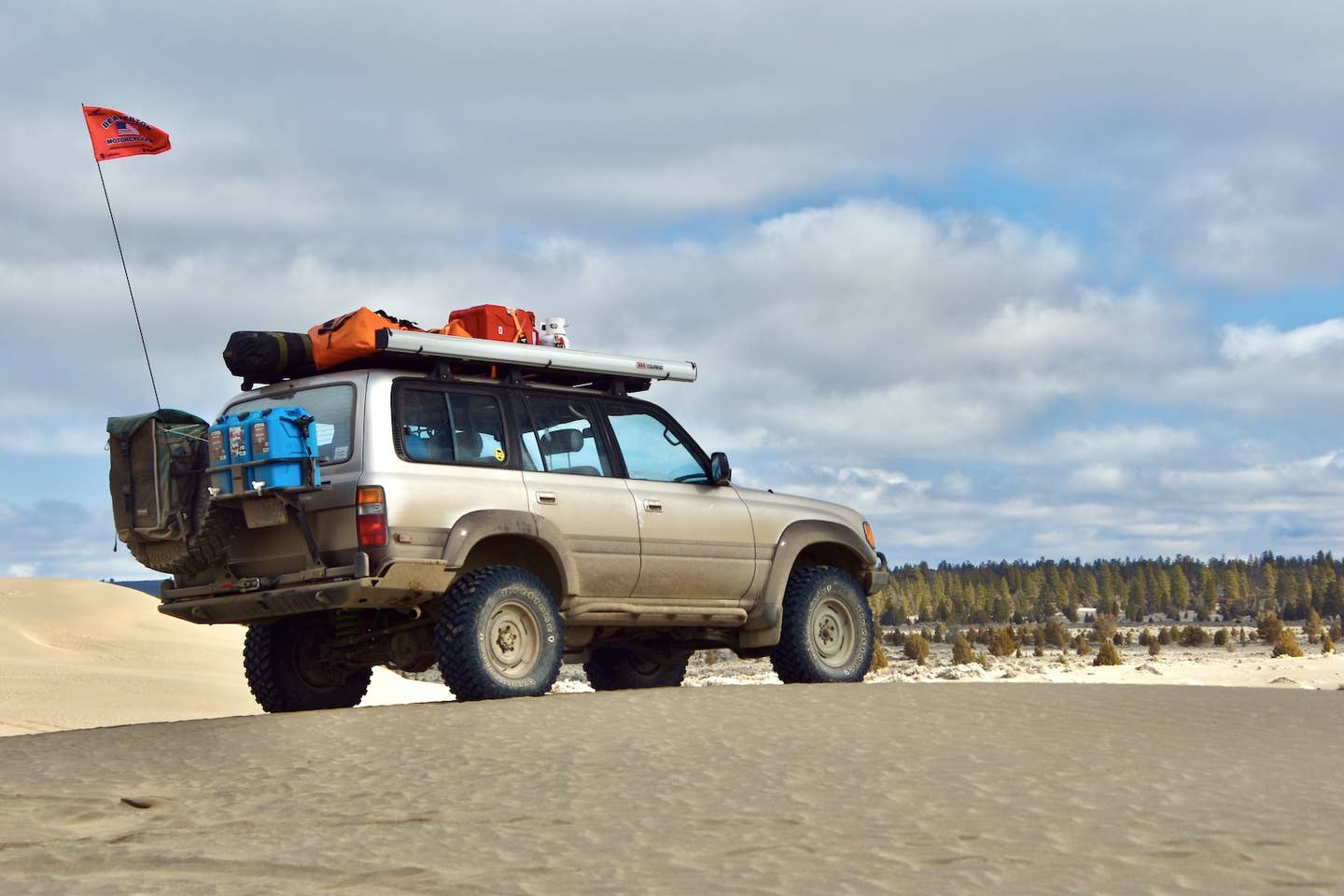 A Toyota Land Cruiser (80-series) on top of a dune in Oregon