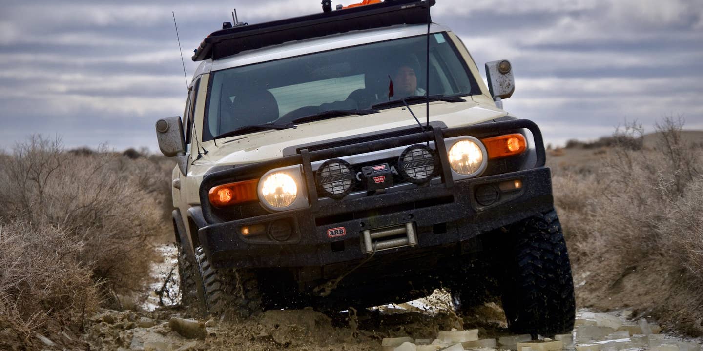 A Toyota FJ Cruiser cracks through a frozen river in the Oregon desert