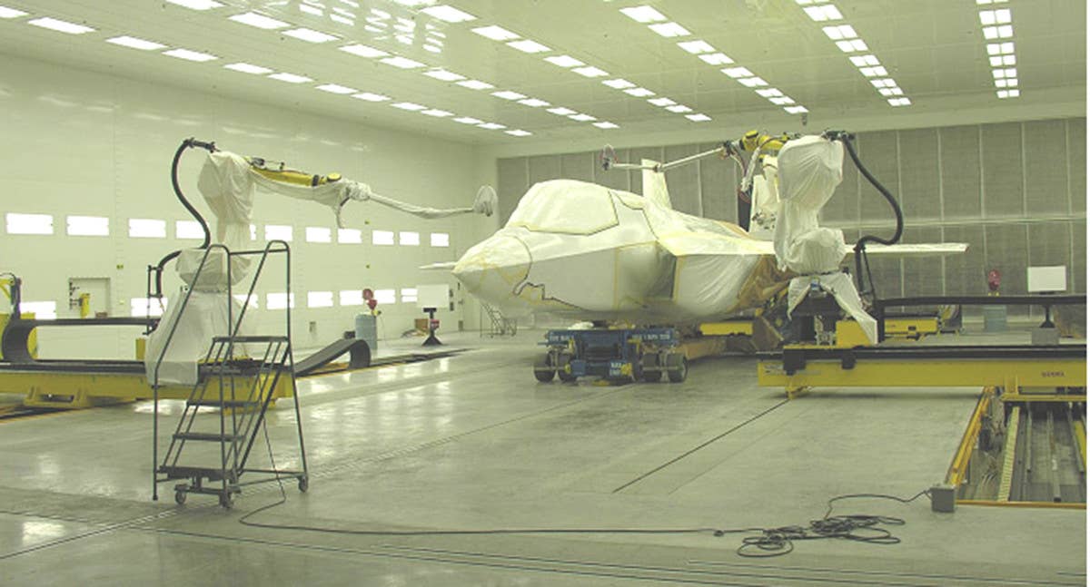 Robotic systems apply a corrosion-resistant coating to a U.S. Air Force F-35A Joint Strike Fighter. <em>USAF</em>