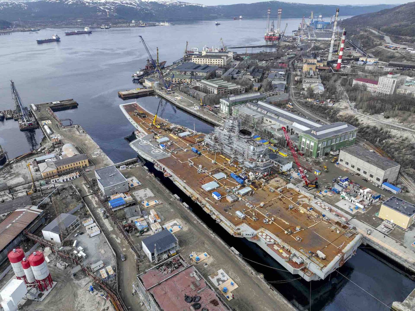 The Russian Navy's lone aircraft carrier, <em>Admiral Kuznetsov</em>, is towed to the 35th squadron shipyard for maintenance and repair works in Murmansk, Russia on May 20, 2022. <em>Photo by Semen Vasileyev/Anadolu Agency via Getty Images</em>