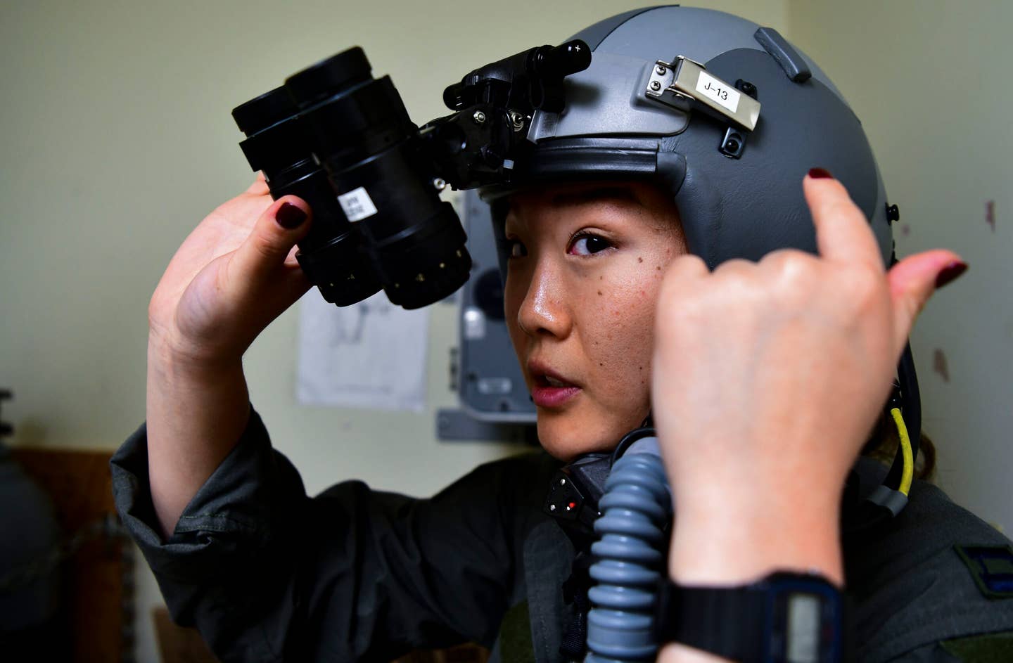 Captain Lisa Choe, 80th Fighter Squadron flight doctor, tests HGU-55/P flight helmet for night vision at Kunsan Air Base, Republic of Korea. <em>Credit: U.S. Air Force photo by Staff Sgt. Jesenia Landaverde</em>