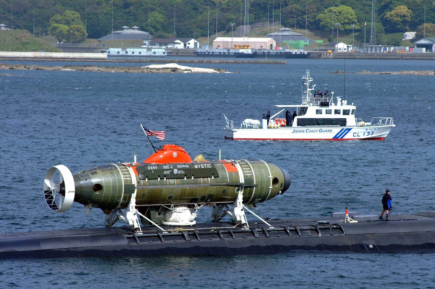 U.S. Navy <em>Los Angeles</em> class attack submarine USS <em>La Jolla</em> (SSN 701) with the deep submergence rescue vehicle <em>Mystic</em> (DSRV-1) attached, is escorted by the Japanese Coast Guard as it pulls out of Sasebo harbor to participate in the submarine rescue Exercise Pacific Reach, April 25, 2002. <em>U.S. Navy photo by Journalist 3rd Class Wes Eplen</em>