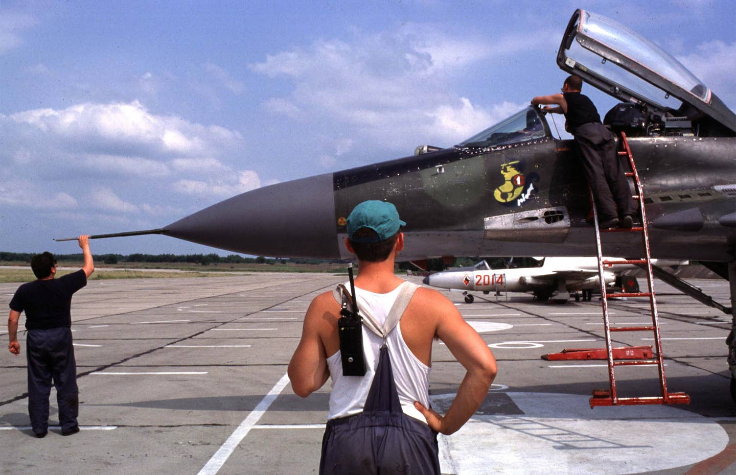Ground crew prepare a Polish Air Force MiG-29A during a joint French-Polish exercise in Mińsk-Mazowiecki, Poland. The fighter wears the brown and green camouflage scheme that was initially still worn by the former Czechoslovak jets. <em>Photo by Piotr Malecki/Getty Images</em>