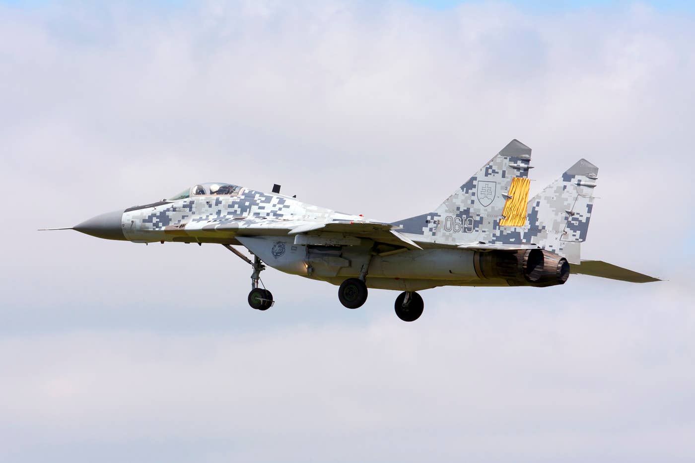 Post-modernization, some Slovakian MiGs received this unique ‘digital’ camouflage scheme. This example added tiger stripes on the rudders for the 2011 NATO Tiger Meet. <em>Rob Schleiffert/Wikimedia Commons</em>
