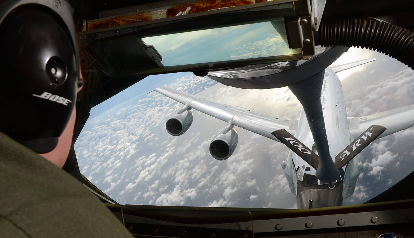 A U.S. Air Force refueling boom operator prepares to make contact with a Royal Air Force RC-135W Rivet Joint off the coast of England in 2014. <em>U.S. Air Force photo/Airman 1st Class Jonathan Light/Released</em>