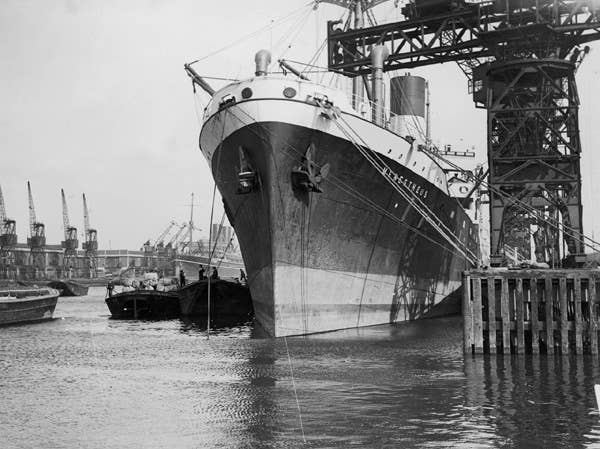 MV <em>Menestheus</em> moored at King George V Dock, East London, prior to its conversion to an auxiliary minelayer, circa. 1940. <em>National Maritime Museum via Wikimedia Commons</em>