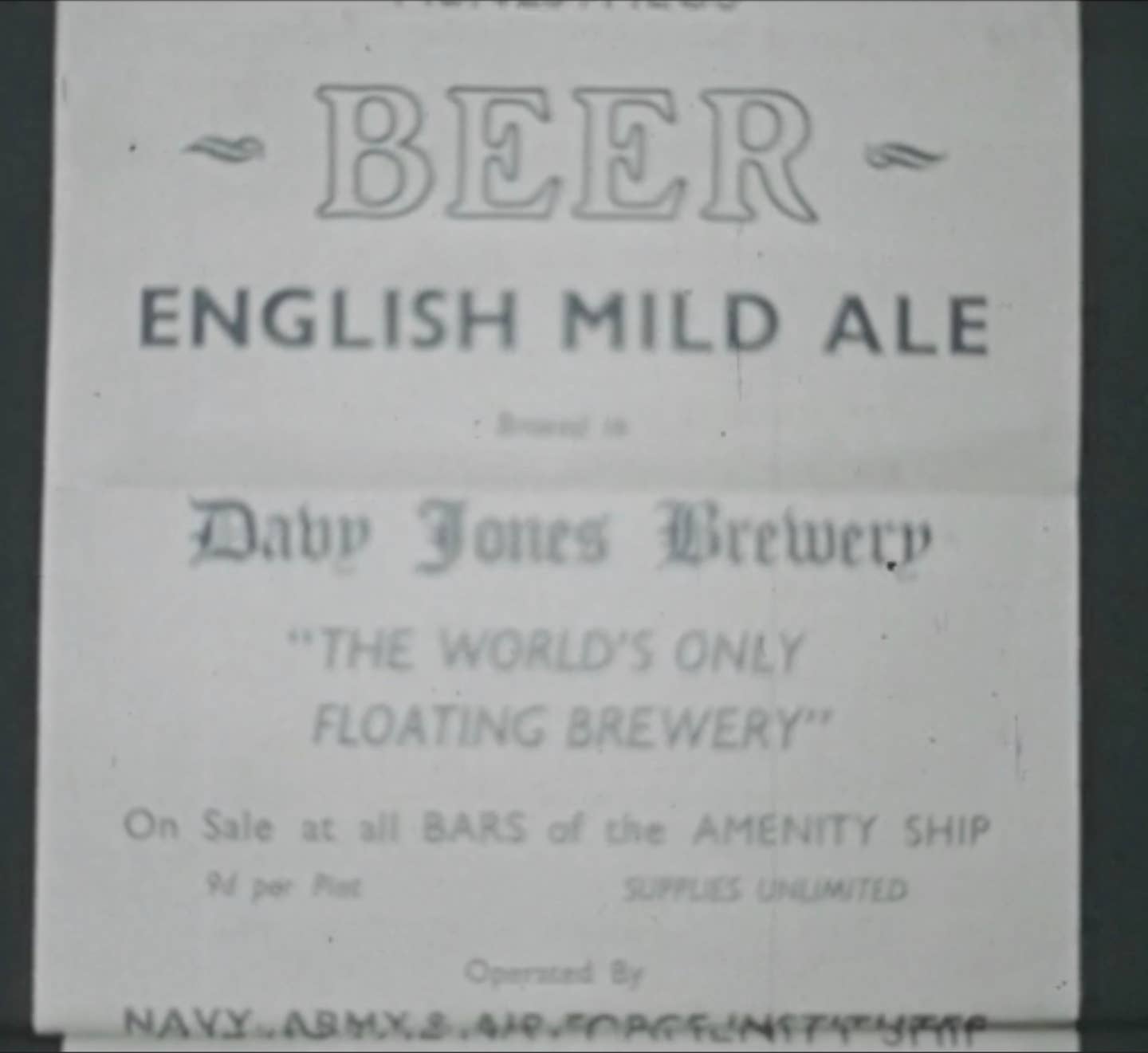 Screen cap from the 1946 film, showing an advertisement for HMS <em>Menestheus’s </em>brewery. <em>Copyright: © IWM</em>