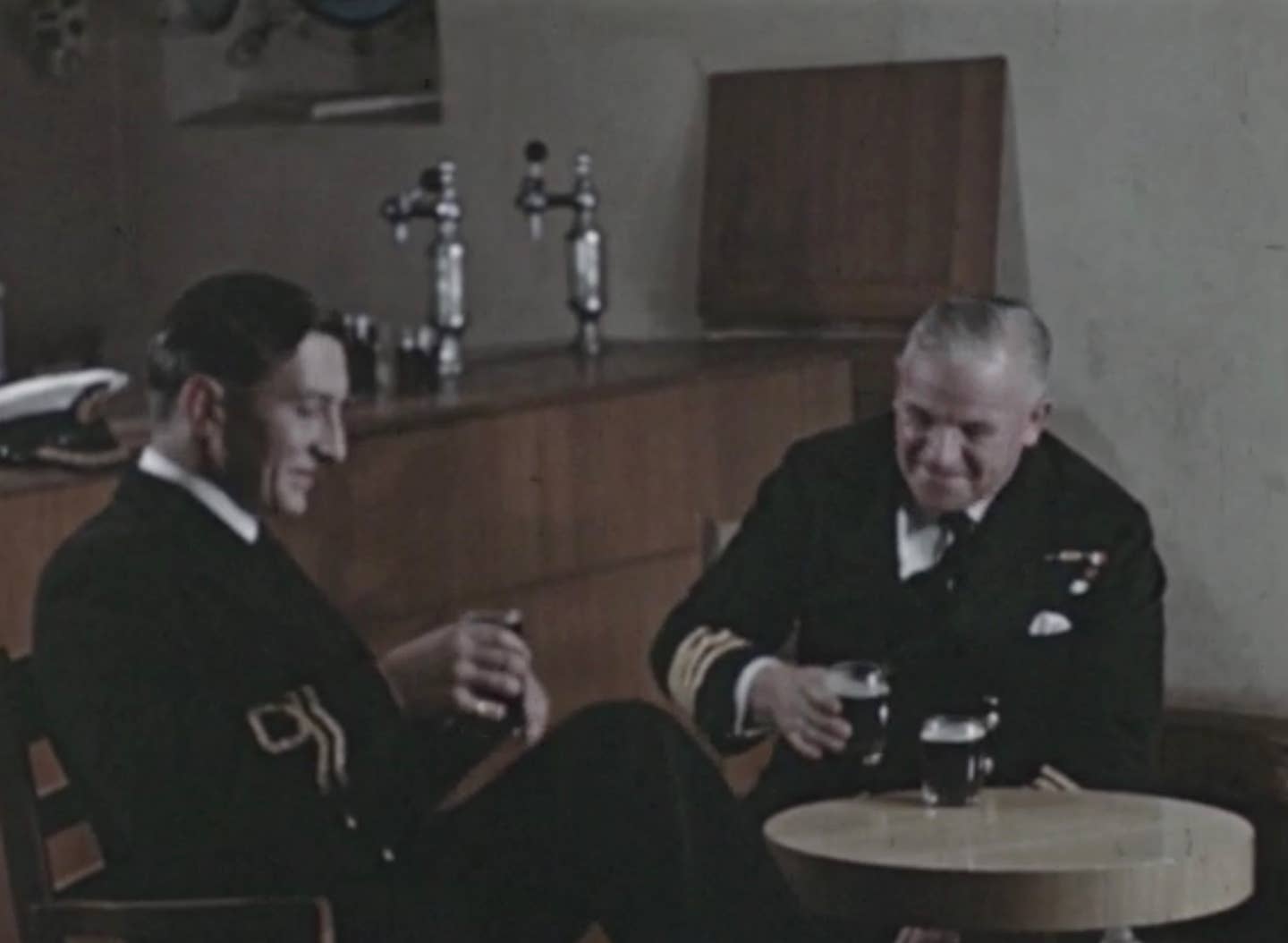 Officers enjoying HMS <em>Menestheus’s</em> brew at one of the ship's bars in the film. <em>Copyright: © IWM</em>