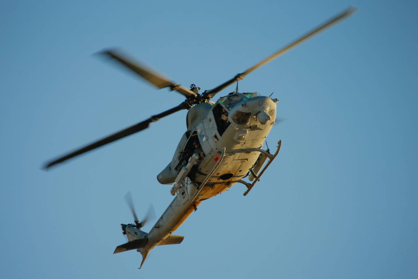A UH-1Y seen carrying an Intrepid Tiger II electronic warfare pod on its right-side hardpoint and a 70mm rocket pod on the other. <em>USMC</em>