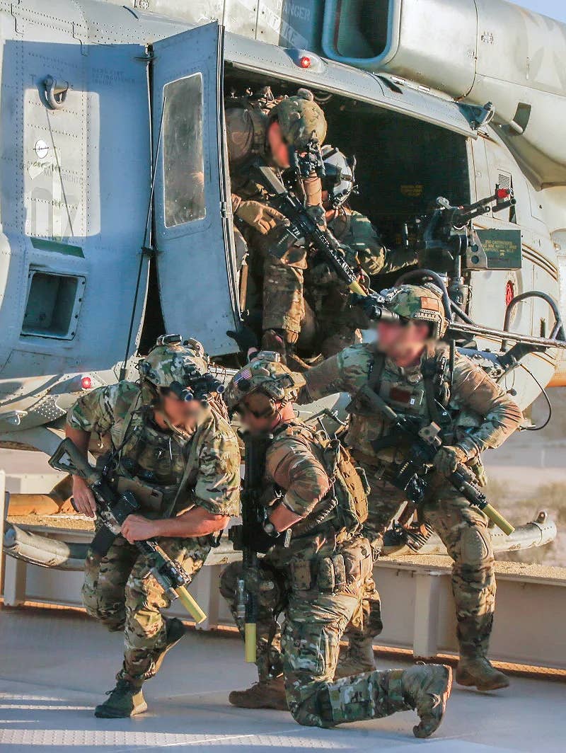 SEALs jump from the UH-1Y out onto the roof. <em>USMC</em>