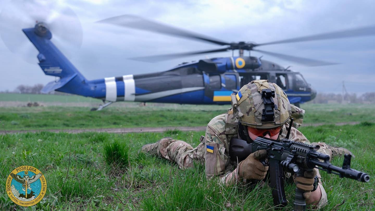 A picture from Ukraine's Defense Intelligence directorate with the Black Hawk in the background. Its various new markings are clearly visible. <em>Ukrainian Defense Intelligence directorate</em>