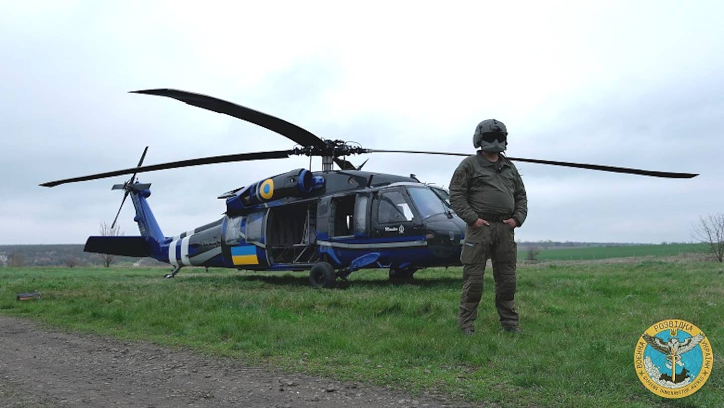 A member of Ukraine's Defense Intelligence directorates stands in front of a UH-60A Black Hawk, the only one currently in service in the country. <em>Ukrainian Defense Intelligence directorate</em>