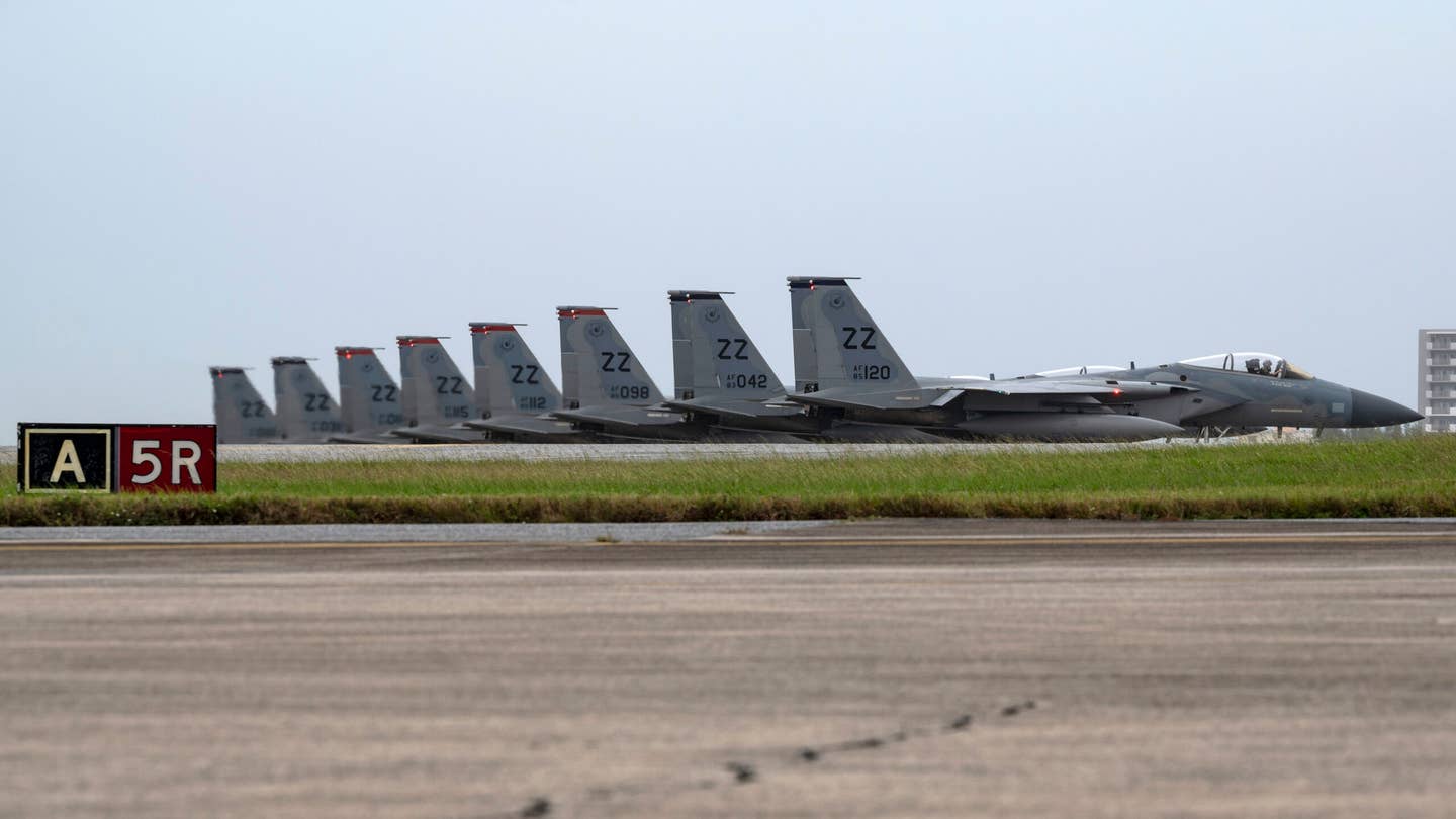 U.S. Air Force F-15C Eagles assigned to the 44th and 67th Fighter Squadrons await clearance for their last take-off from Kadena Air Base, Japan, December 1, 2022. As a part of its modernization plan, the 18th Wing retired its aging fleet of F-15C/Ds that had been in service for more than four decades. <em>U.S. Air Force photo by Senior Airman Jessi Roth</em>