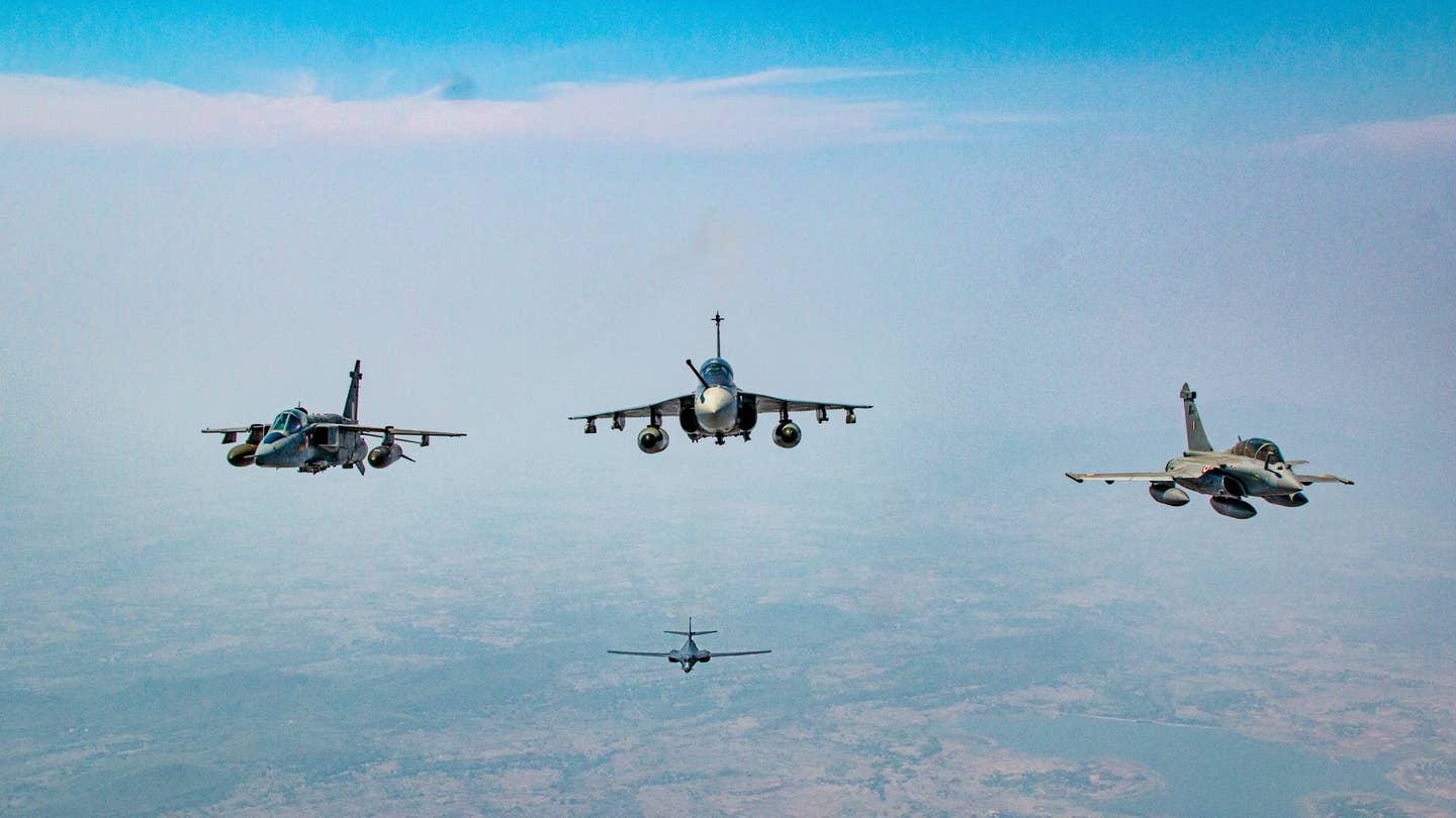 Three of the four Indian Air Force fighter jets involved in Cope India 23 — Jaguar, Tejas, and Rafale — with a B-1B in the background. <em>IAF</em>