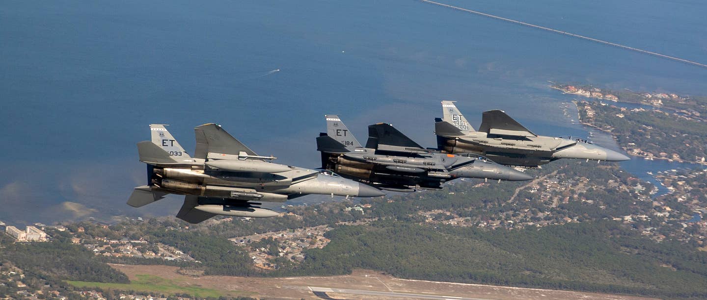 An F-15EX (furthest from the camera) is accompanied by an F-15C and and F-15E as it heads to its new home station, Eglin Air Force Base, Florida, in March 2021. <em>U.S. Air Force photo by Tech. Sgt. John Raven</em>