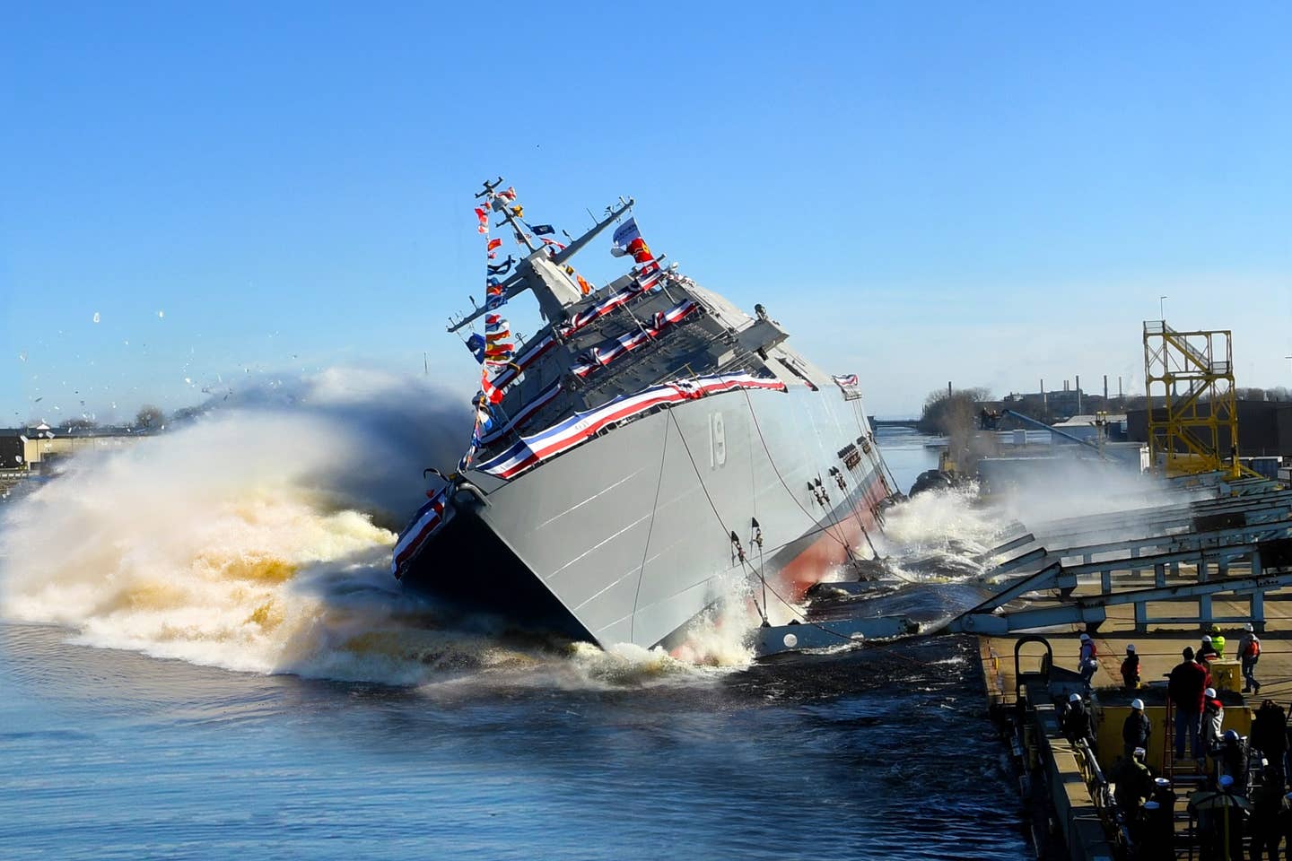 Littoral combat ship USS St. <em>Louis</em> (LCS 19) launches sideways into the Menominee River in Marinette, Wisconsin, following its christening, December 15, 2018, by ship's sponsor Barbara Taylor. <em>U.S. Navy photo</em>
