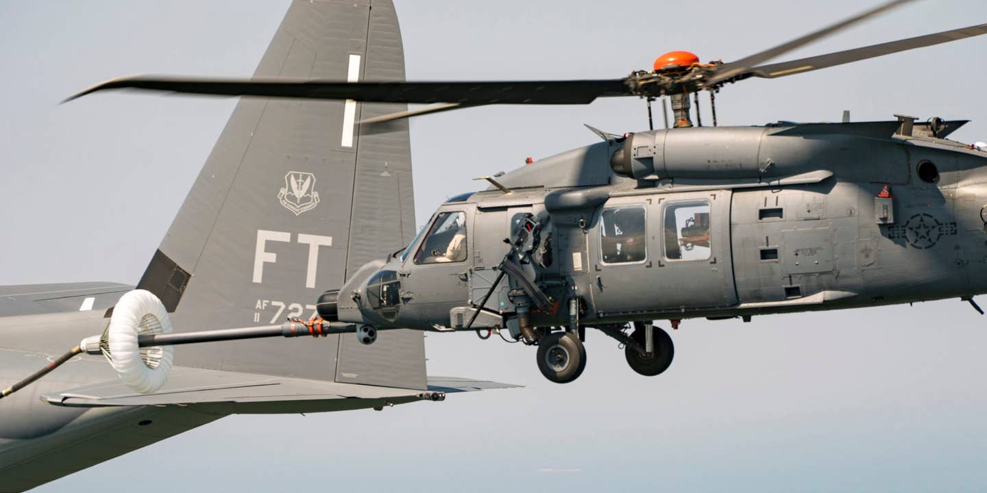 An HH-60W Jolly Green II connected with a HC-130J