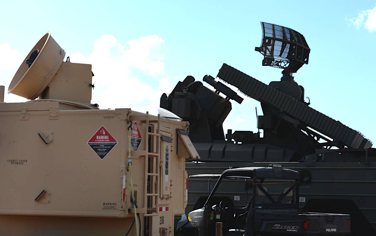 An AN/VPQ-1 Tactical Radar Threat Generator sits next to what appears to be a mockup of a Soviet-designed 9K33 Osa surface-to-air missile system at the Camp Shelby Joint Forces Training Center in Mississippi during Exercise Southern Strike 17. <em>USAF</em>