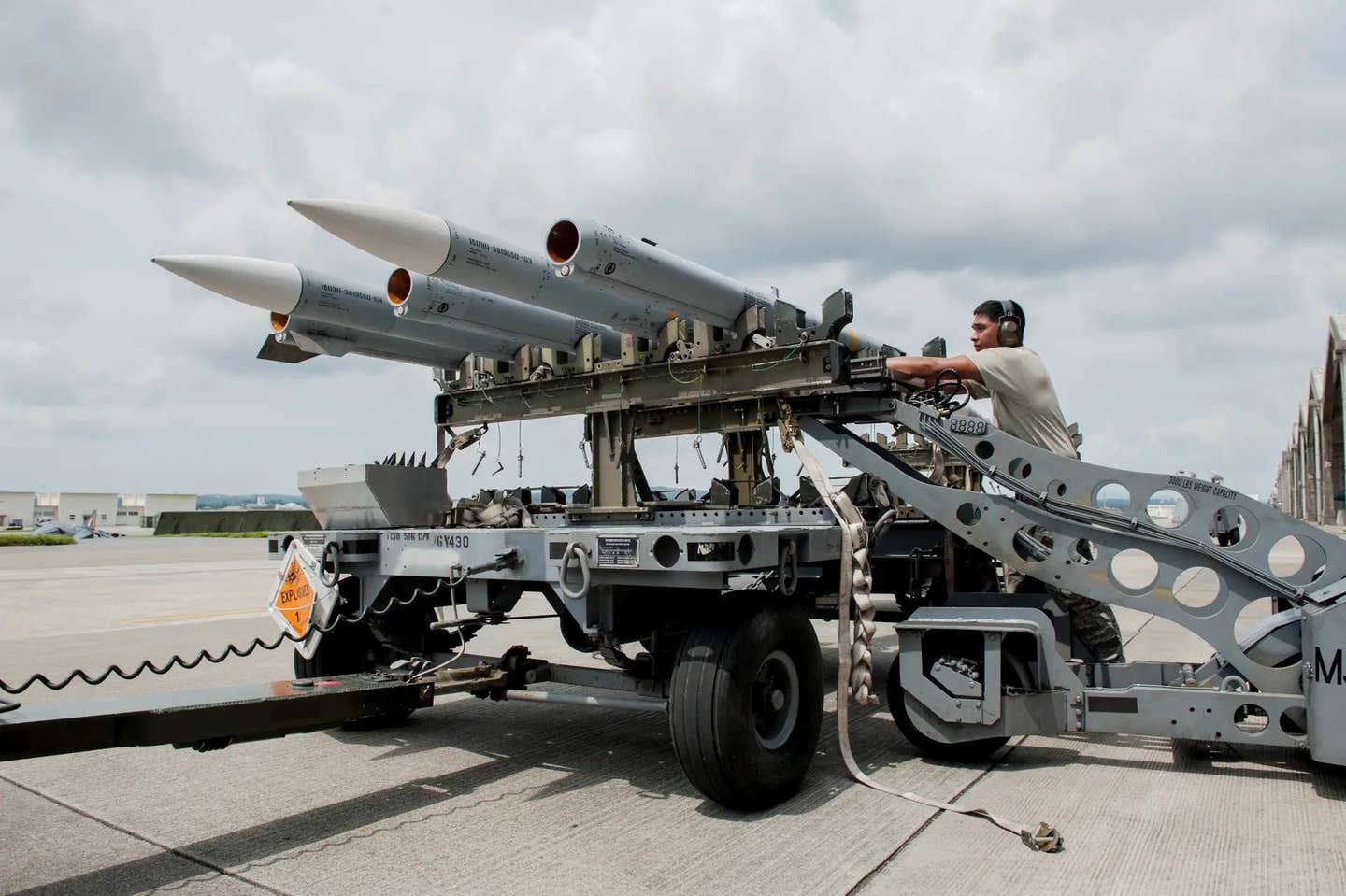 Air Force personnel prepare AIM-120 AMRAAM missiles for loading onto F-15 fighters at Kadena Air Base in Japan during an exercise. <em>USAF</em>