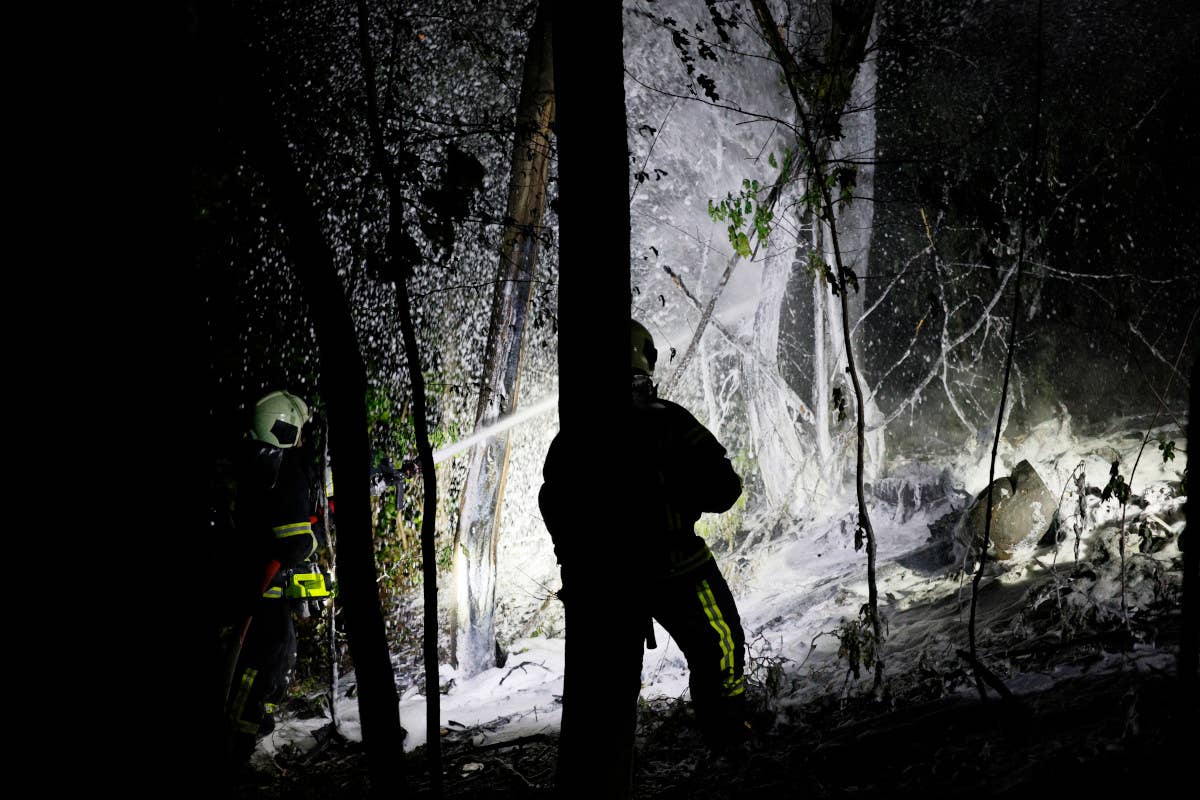 Firefighters spray foam on the downed TB2. <em>AP Photo/Alex Babenko</em>