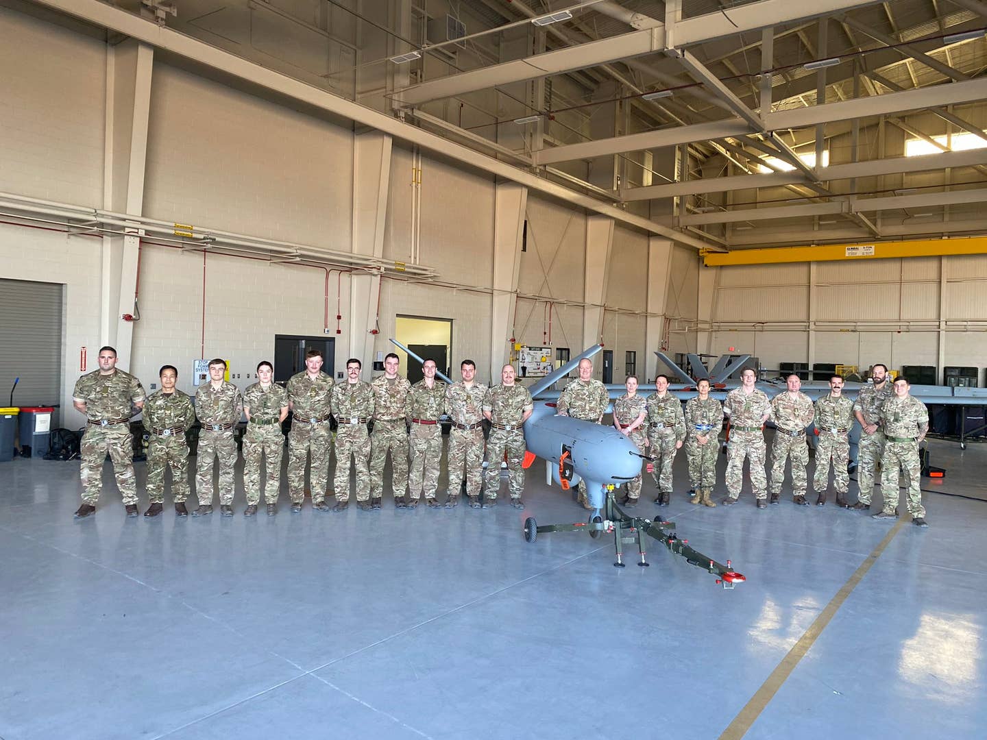 British Army personnel pose with three Watchkeeper drones. <em>British Army Staff USA via Twitter</em>