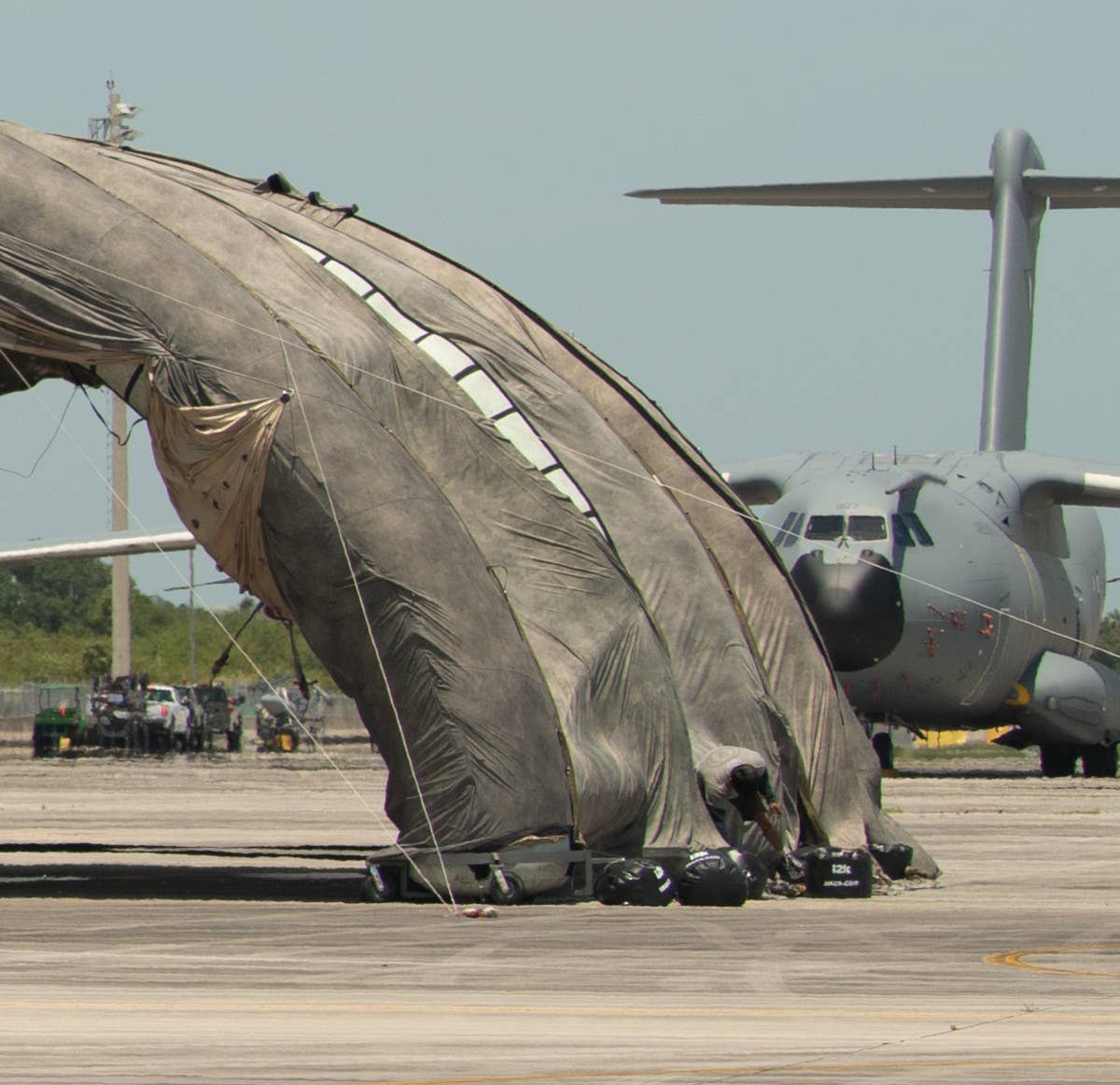 An Airbus A400M belonging to an unknown operator seen behind the "prototype portable camouflage, concealment, and deception hangar" at Homestead Air Reserve Base. <em>Air National Guard</em>