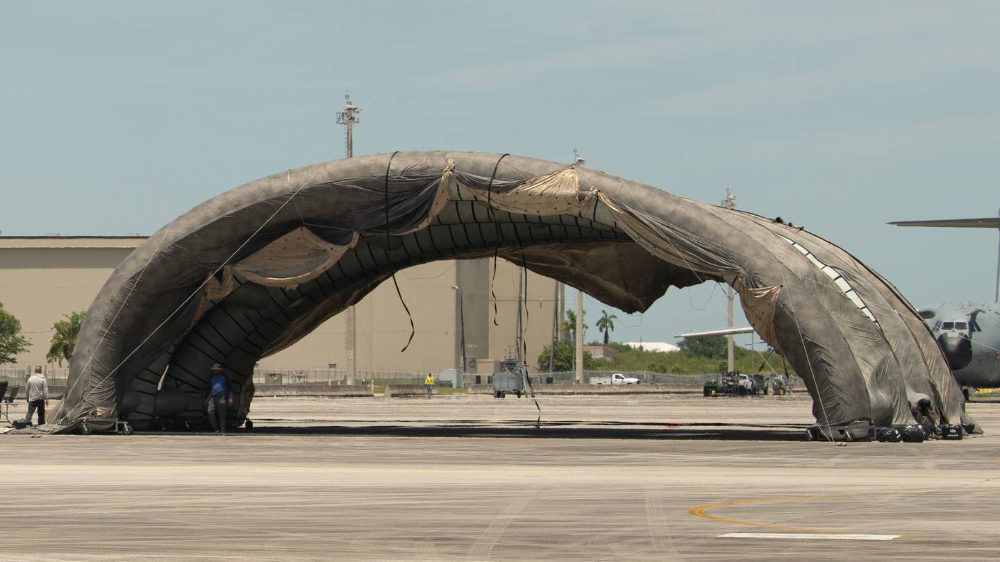 The "prototype portable camouflage, concealment, and deception hangar" at Homestead Air Reserve Base during Exercise Hoodoo Sea. <em>Air National Guard</em>