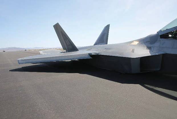 The F-22 sitting on Fallon's runway on its belly. <em>USAF mishap investigation photo</em>