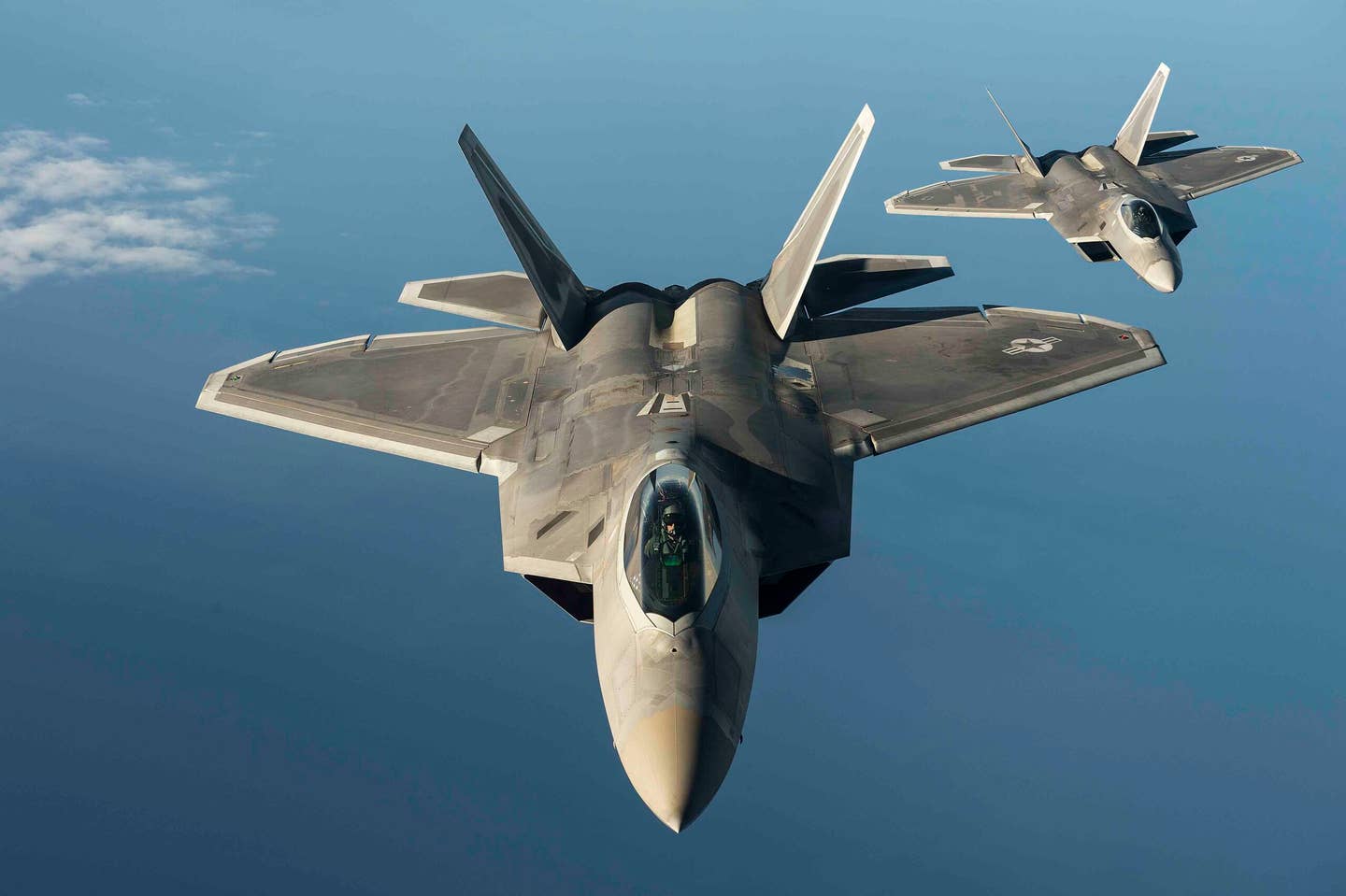 Two U.S. Air Force F-22 Raptors from the 95th Fighter Squadron, Tyndall Air Force Base, Fla., fly over the Baltic Sea, Sept. 4, 2015. <em>U.S. Air Force photo by Tech. Sgt. Jason Robertson</em>